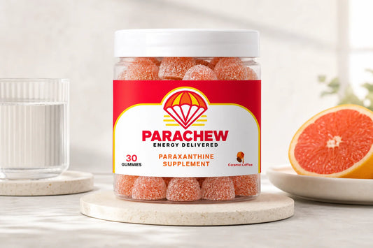 Parachew paraxanthine gummies beside a cup of decaf coffee on a marble surface, illustrating the paraxanthine vs decaf comparison
